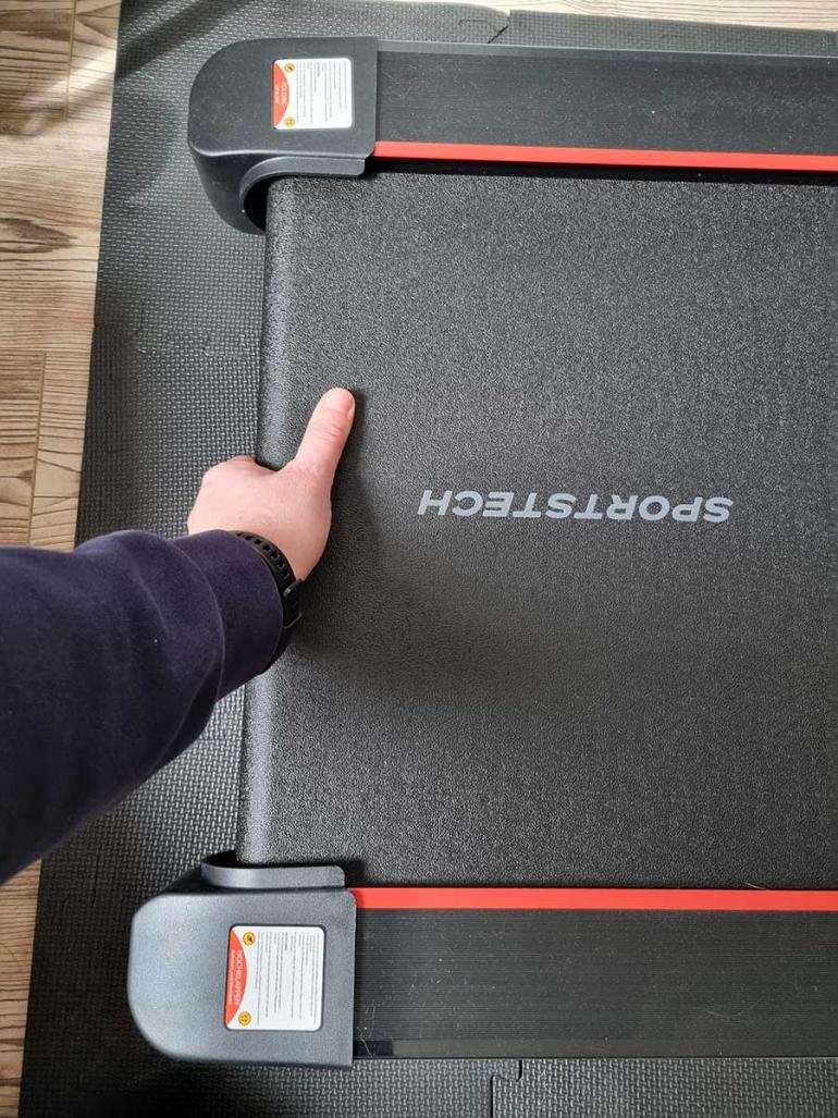 Sportstech Laufband bei der Wartung des Laufgurts