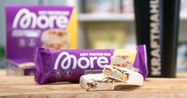 Angeschnittener More Soft Protein Bar Peanut Caramel mit sichtbarer Karamellfüllung und weißem Schokoladenüberzug im Produkttest.