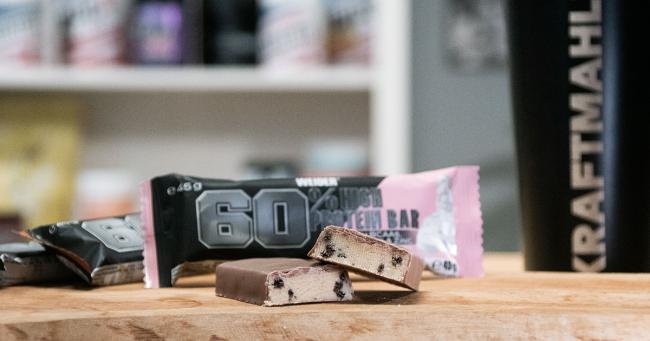 Angeschnittener Weider 60 % Protein Bar mit sichtbaren Stückchen im Produkttest.